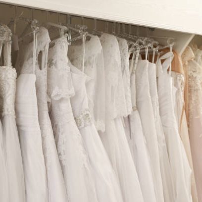 Different wedding dresses on hangers in boutique