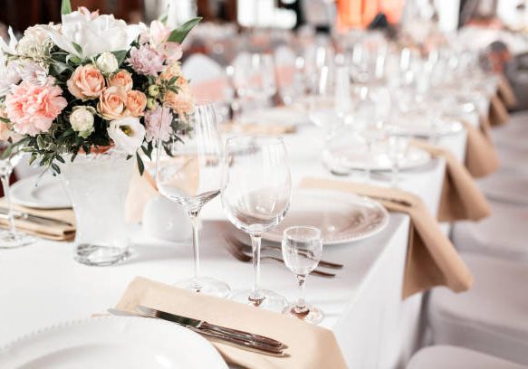 Tables set for an event party or wedding reception. luxury elegant table setting dinner in a restaurant. glasses and dishes